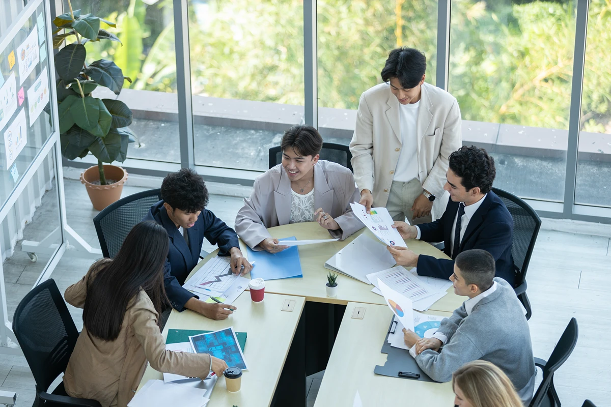 Business team running a strategy meeting in an office with natural light